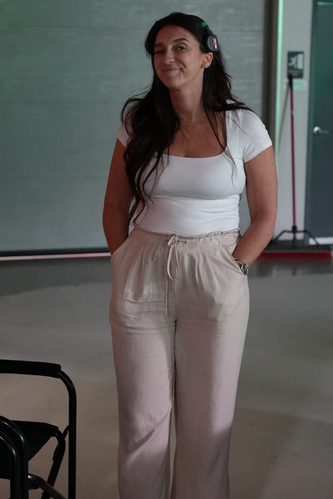 Keri smiling on set while wearing a production headset