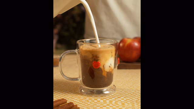 Milk pouring into an iced coffee during the Joy Local Coffee menu shoot