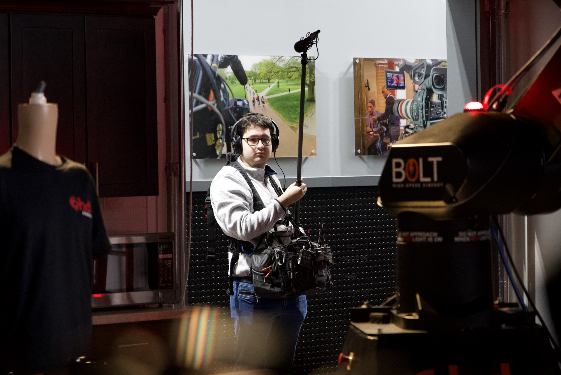 Noah Kuhr holding a boom microphone with a sound bag