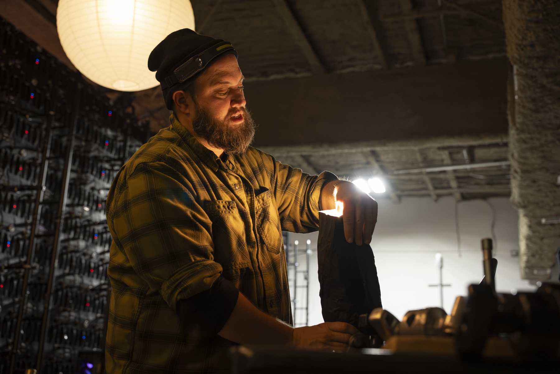 Vincent Restivo working beside a warm production light