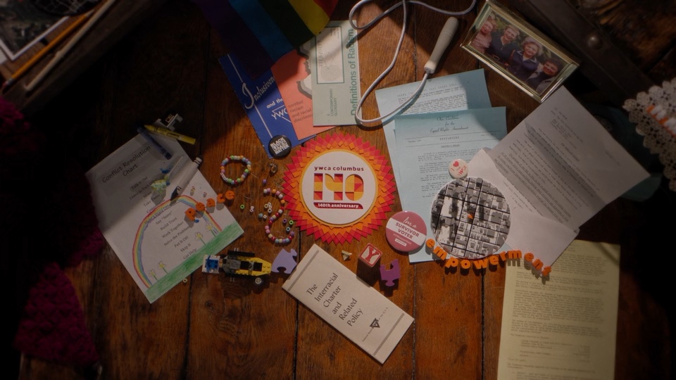 Archival documents and objects photographed on a tabletop for YWCA